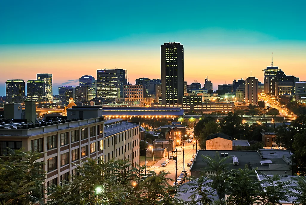 City skyline at sunset with downtown towers and streetlights